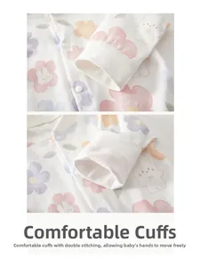 Detail of ribbed cuffs and double stitching on long-sleeve cotton baby bodysuit