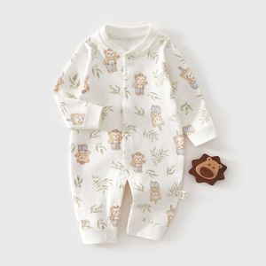 Detail of baby cotton romper featuring cartoon bear patterns and snap button closure