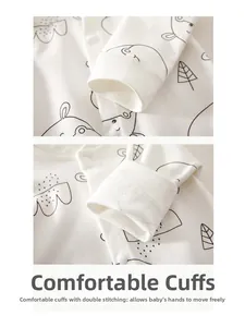 Detail of comfortable ribbed cuffs on white cotton baby jumpsuit with cartoon animal prints
