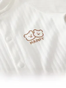 Close-up of white ribbed cotton baby bodysuit with cute brown bear prints and snaps