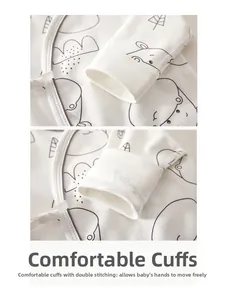 Close-up of baby bodysuit cuffs showing soft cotton texture and hippo print details