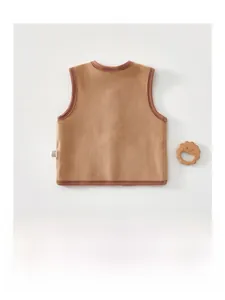 Detailed close-up of warm brown polar fleece baby vest with high-quality binding