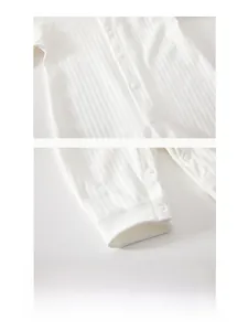 Close-up of soft cotton baby romper featuring resin snaps and delicate bear embroidery