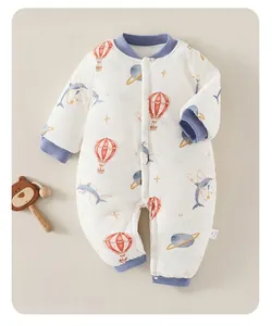 Detail of quilted cotton baby romper with blue dolphin print for winter warmth