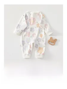 Detail of newborn long sleeve floral cotton romper with soft floral pattern and side label