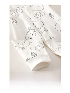 Detail of baby cotton onesie with resin snap buttons and cartoon animal print