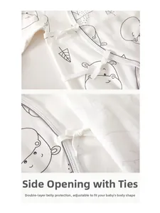 Detail of soft cotton baby romper featuring kimono tie closure and hippo print pattern