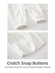 Detail view of cotton baby romper snap buttons and soft ribbed knit fabric texture