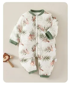 Detail of baby winter romper with raccoon and palm leaf print and green ribbed cuffs