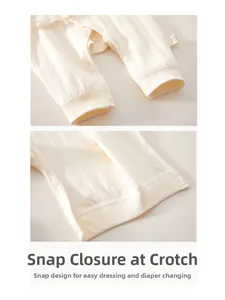 Detailed macro view of snap buttons on soft ribbed cotton baby romper for easy diaper change