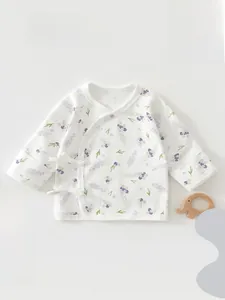 Detail of soft cotton newborn kimono top featuring purple lavender patterns for infants