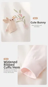 Detail of pink cotton baby romper with bunny embroidery and elastic ribbed cuffs