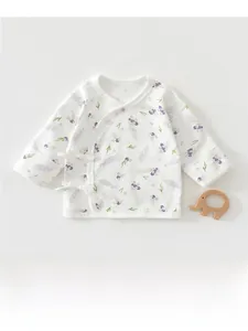 Detail view of cotton newborn baby wrap top featuring purple berry print and tie closure