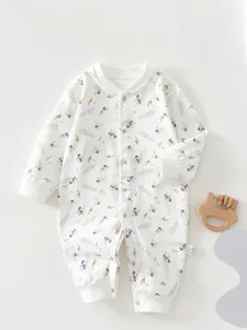 Detailed macro view of pure cotton baby romper with purple berry print and snap buttons