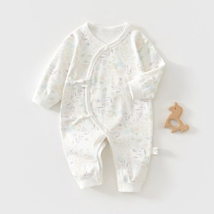 Detail of floral infant romper with soft side-tie closure and fabric wash label