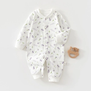 Detail of baby cotton romper with berry print and easy snap-on buttons closure