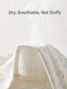 Breathable cotton baby blanket with floral pattern showing steam through fabric
