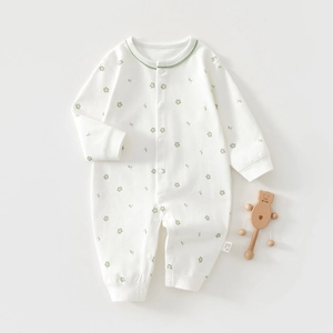 Detail of baby floral long sleeve romper with convenient snap buttons and soft cotton texture