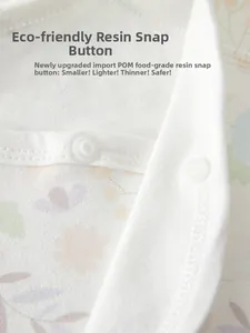 Detail of eco-friendly food-grade resin snap buttons on floral organic cotton baby clothes