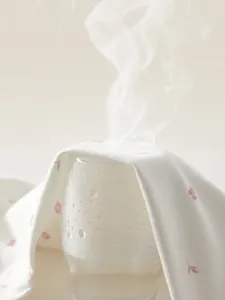 Breathable floral cotton baby romper fabric showing steam penetration for comfort