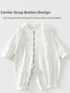 Detail of baby cotton romper with floral print and convenient snap button closure