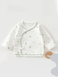 Detail of newborn floral cotton kimono top with side ties and green trim finish