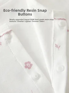 Detail of eco-friendly resin snap buttons on floral pattern pure cotton baby jumpsuit