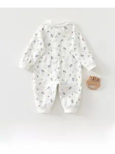 Detailed macro shot of white cotton baby romper with soft lavender floral pattern print