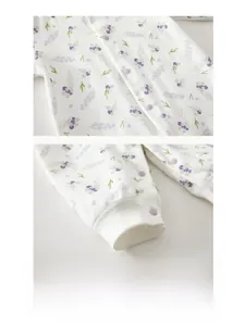 Detailed view of high-quality resin snaps on a cotton floral baby romper bodysuit