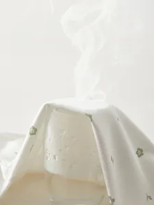 Breathable cotton newborn undershirt with floral pattern showing steam permeability