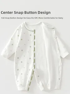 Detail of baby cotton romper featuring snap buttons and a delicate green floral pattern