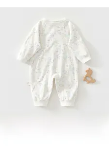 Detail view of cotton baby romper with soft floral patterns and wooden horse prop