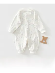 Close-up of floral newborn romper showing long sleeves, ribbed cuffs and soft cotton texture