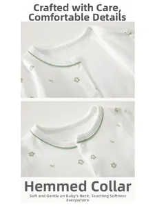 Detail of baby cotton romper with green floral print and snap button neckline