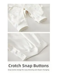 Close-up of snap button crotch on floral cotton baby romper for easy diaper changes