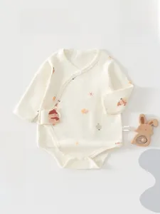 Close-up of beige cotton baby bodysuit featuring snowman embroidery and house prints
