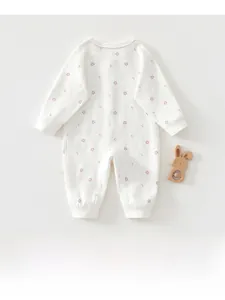 Detail of baby cotton long-sleeve bodysuit with floral print and pink wavy lace collar