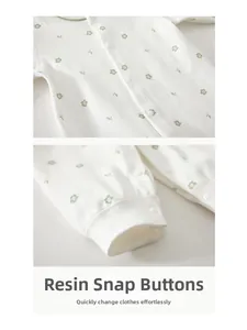 Detail view of resin snap buttons and floral cotton fabric on newborn baby romper