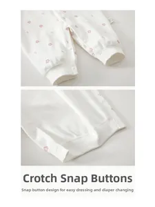 Close-up of bottom snap button closure on floral baby romper for easy diaper changes