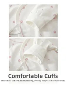 Detail of baby onesie sleeve with pink floral patterns and ribbed cuffs for newborns