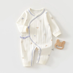 Detailed close-up of newborn organic cotton onesie fabric texture and cute bear print