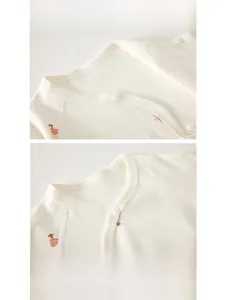 Detail of baby bodysuit collar with snap buttons and cotton fabric with star print