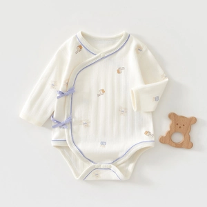 Close-up of baby bodysuit featuring ribbed cotton texture and cute bear print pattern