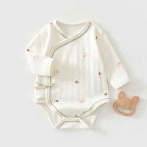 Close-up of baby long sleeve bodysuit with autumn leaf print and soft ribbed cotton texture