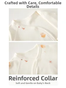 Detail of soft cotton baby romper with bound neckline and orange house patterns
