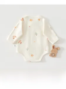 Detail of baby long sleeve bodysuit featuring cute cartoon snowman prints and side label