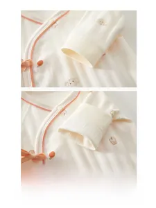 Close-up of soft cotton baby romper cuffs with neat stitching and cute bear prints