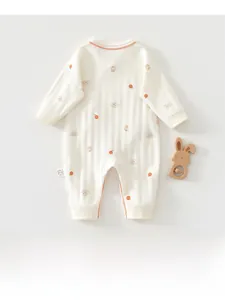 Detailed flat lay of newborn cotton romper featuring cartoon bear and orange prints