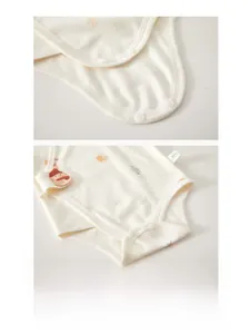 Detailed view of three snaps on the crotch of a soft cotton baby bodysuit for easy diaper change