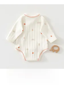 Close-up of baby bodysuit featuring cotton ribbed texture and cute cartoon animal prints